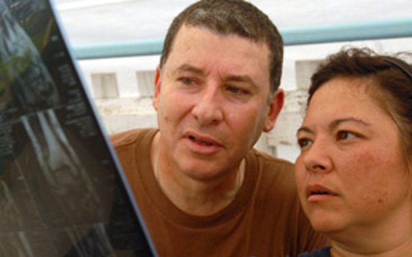 Maj. Ricardo Rodrigues and Lt. Cmdr. Kimberly Roman examine a patient's x-ray.