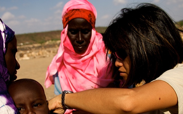 Sgt. 1st Class Marites Cabreza checks the breathing of a sick villager.