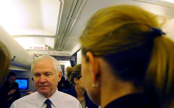 Secretary Gates talks to reporters on a plane.
