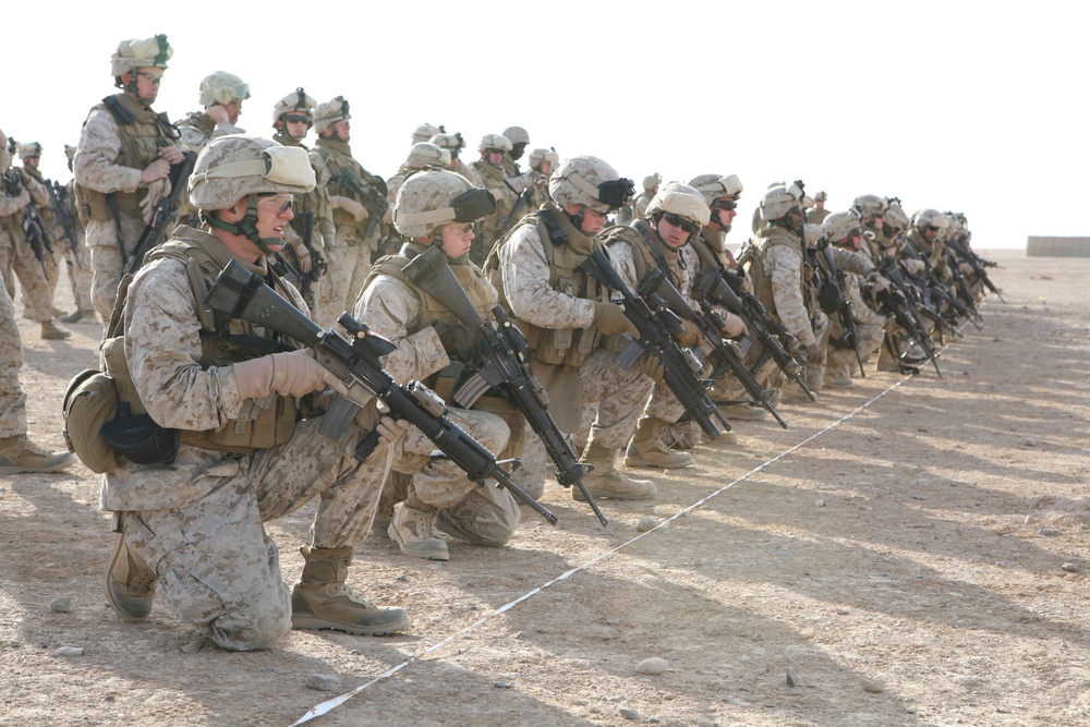 U.S. Marines kneel at the firing line.
