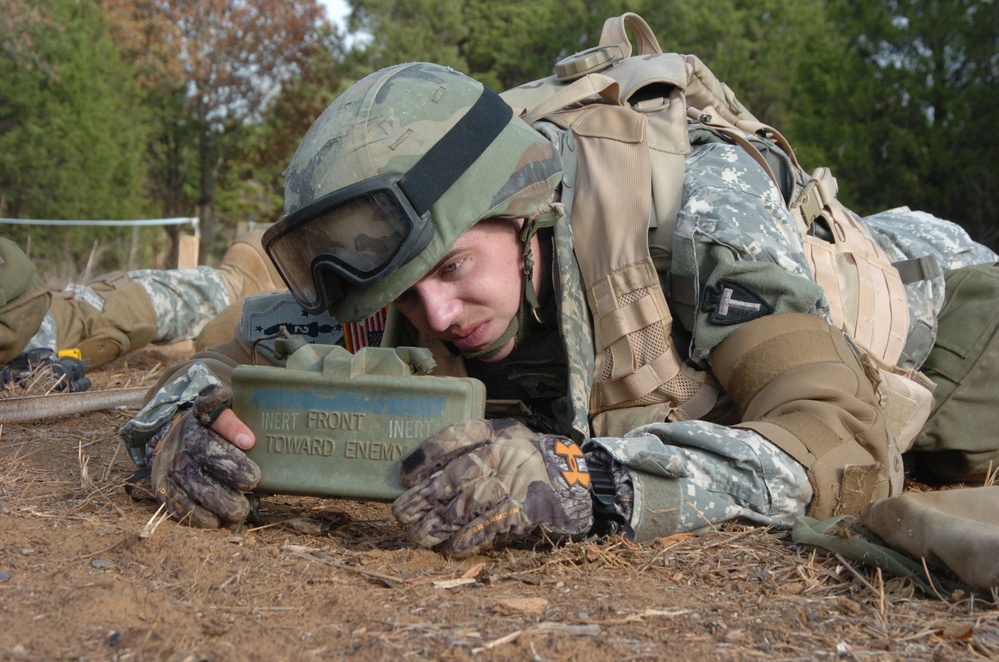 A U.S Army soldier sets up a Claymore anti-personnel mine.