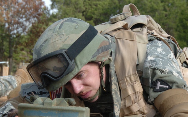 A U.S Army soldier sets up a Claymore anti-personnel mine.