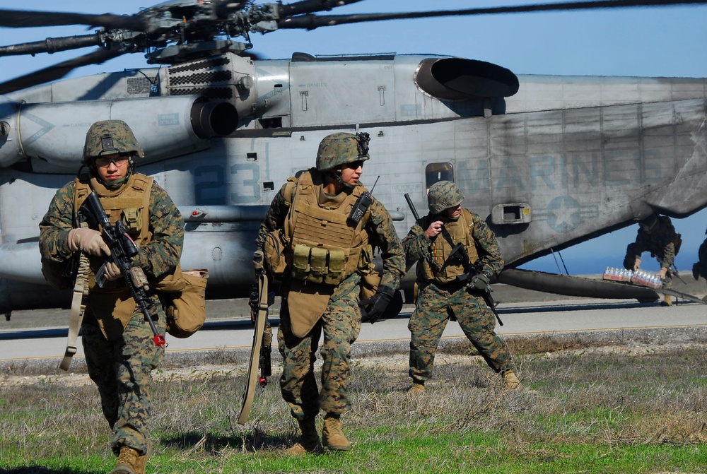 U.S. Marines run towards their security positions.