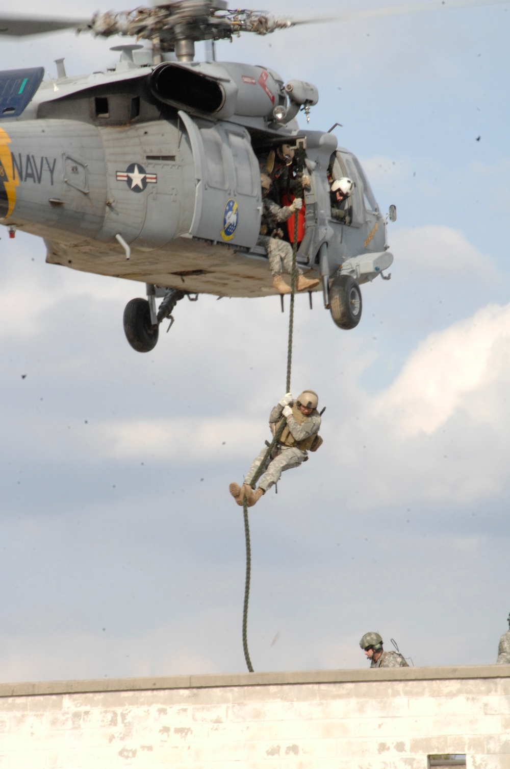 DVIDS - Images - A coalition service member slides down a fast rope.