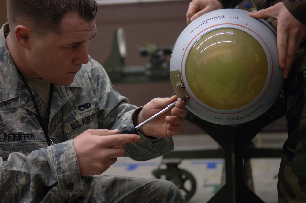 Staff Sgt. Timothy Pfeiffer removes a panel from an AGM-65 Maverick missile.