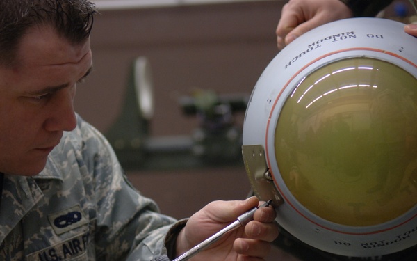 Staff Sgt. Timothy Pfeiffer removes a panel from an AGM-65 Maverick missile.