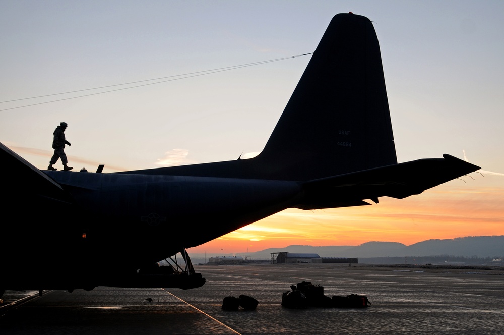 A U.S. Air Force airman inspects a C-130 Hercules aircraft.