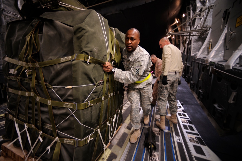 Sgt. Robert McNeely loads a container delivery system of food.