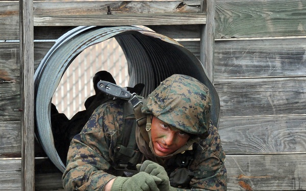 U.S. Marine Corps officer candidate Timothy Schultz negotiates an obstacle.