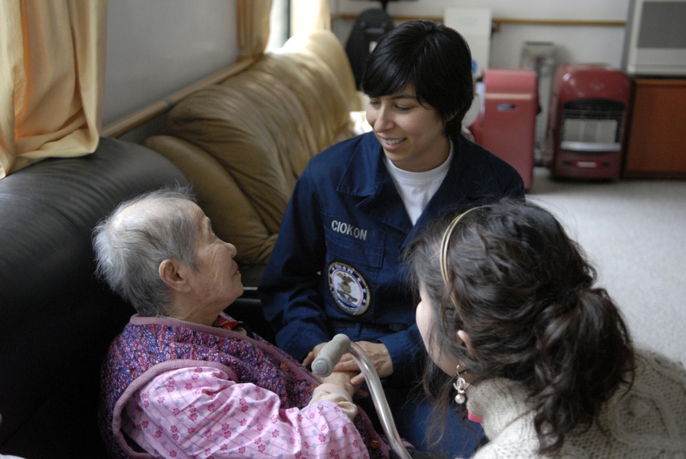 Seaman Lisa Ciokon visits a resident at the Junghwa Noin Yoyangwon Senior Citizens home.