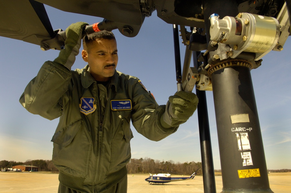 Staff Sgt. Pedro Melendez performs preflight checks.