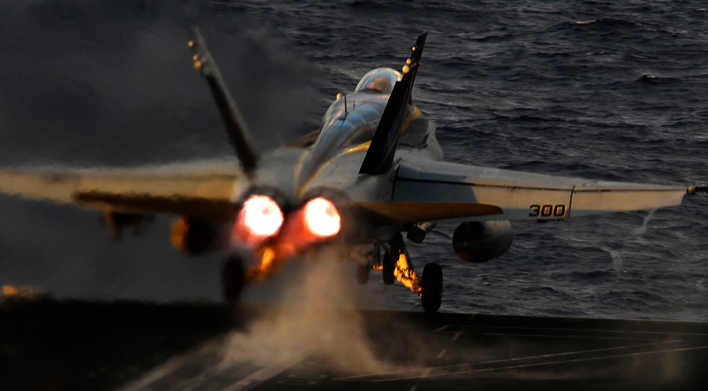 A U.S. Navy F/A-18C Hornet aircraft launches from the flight deck.
