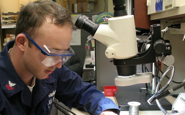 Petty Officer 1st Class Phillip Makuch conducts a component replacement.