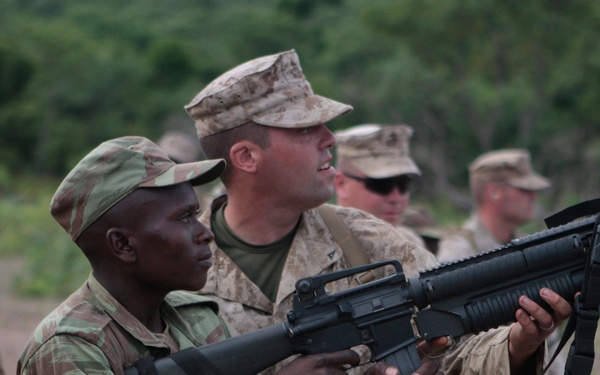 Lance Cpl. Blake M. Pharr fires M-203 grenade launchers with soldiers from the Beninese army.