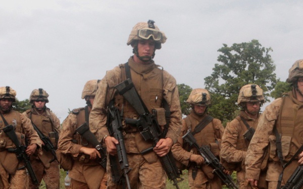 U.S. Marines walk to a firing line.