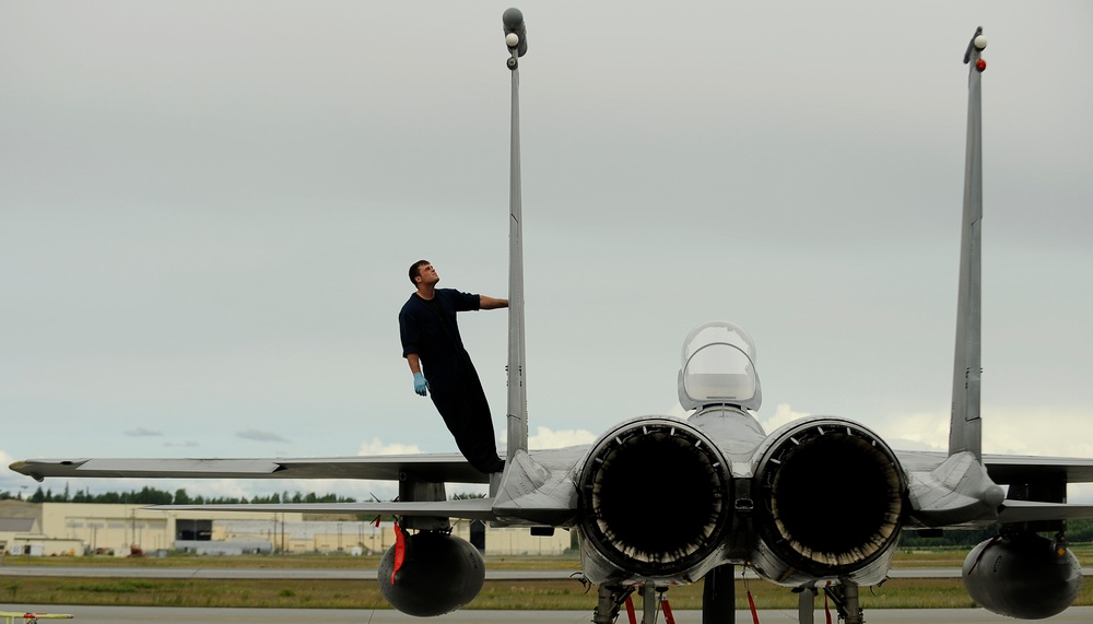 Senior Airman Zach Gartner recovers an F-15 Eagle fighter aircraft.