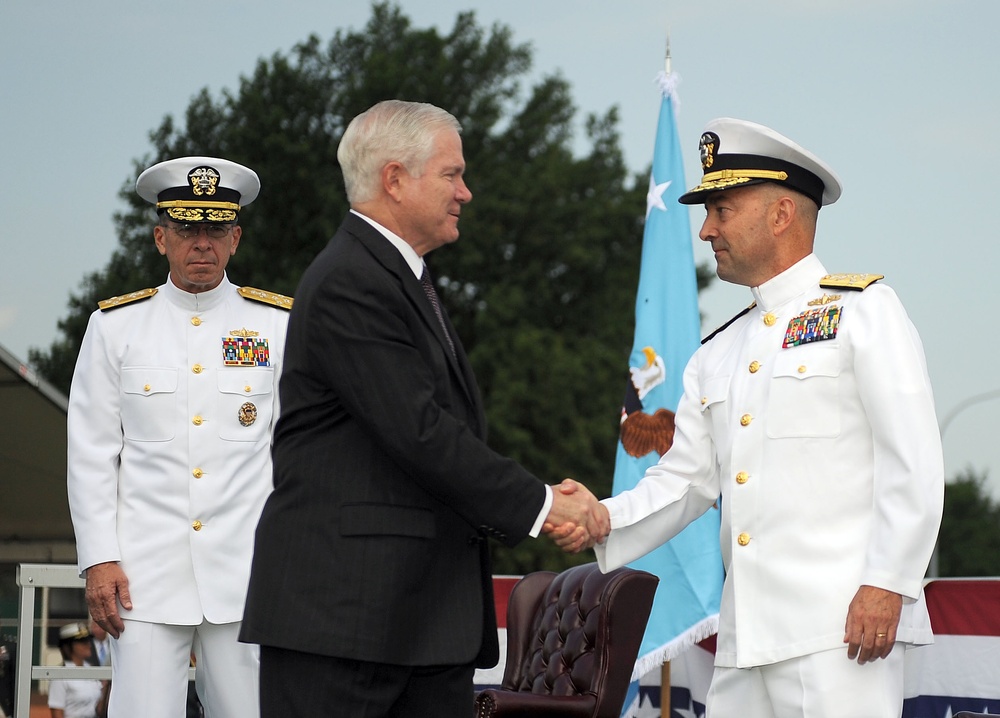 Secretary Gates congratulates incoming European Command Commander Adm. James Stavridis.