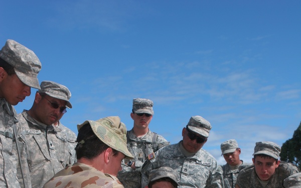 U.S. Army soldiers receive a period of instruction from an Australian soldier.