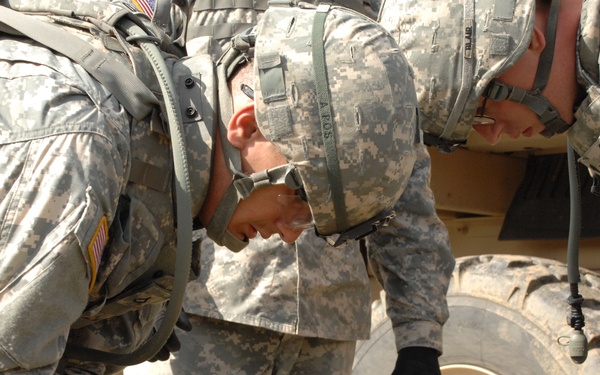 U.S. Army soldiers place fuses on artillery shells.