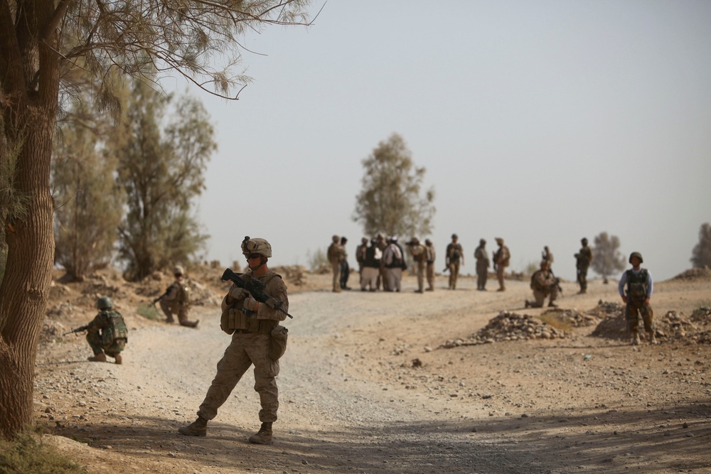 Afghan soldiers and U.S. Marines conduct a road reconnaissance patrol.
