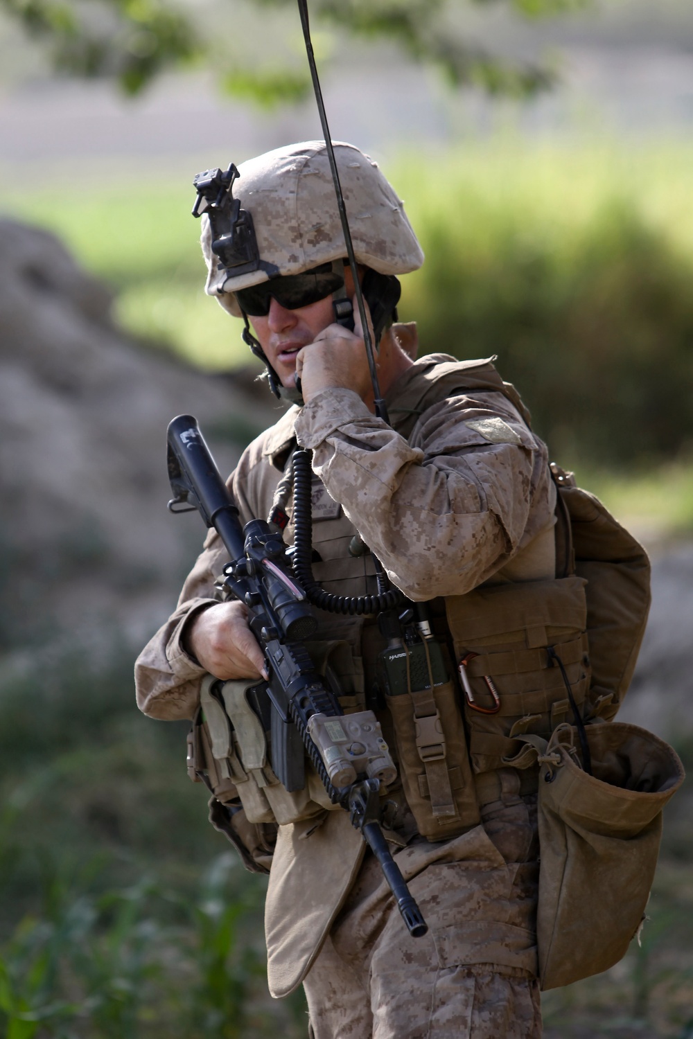 Capt. Jason Condon communicates with headquarters during a civil affairs group patrol.
