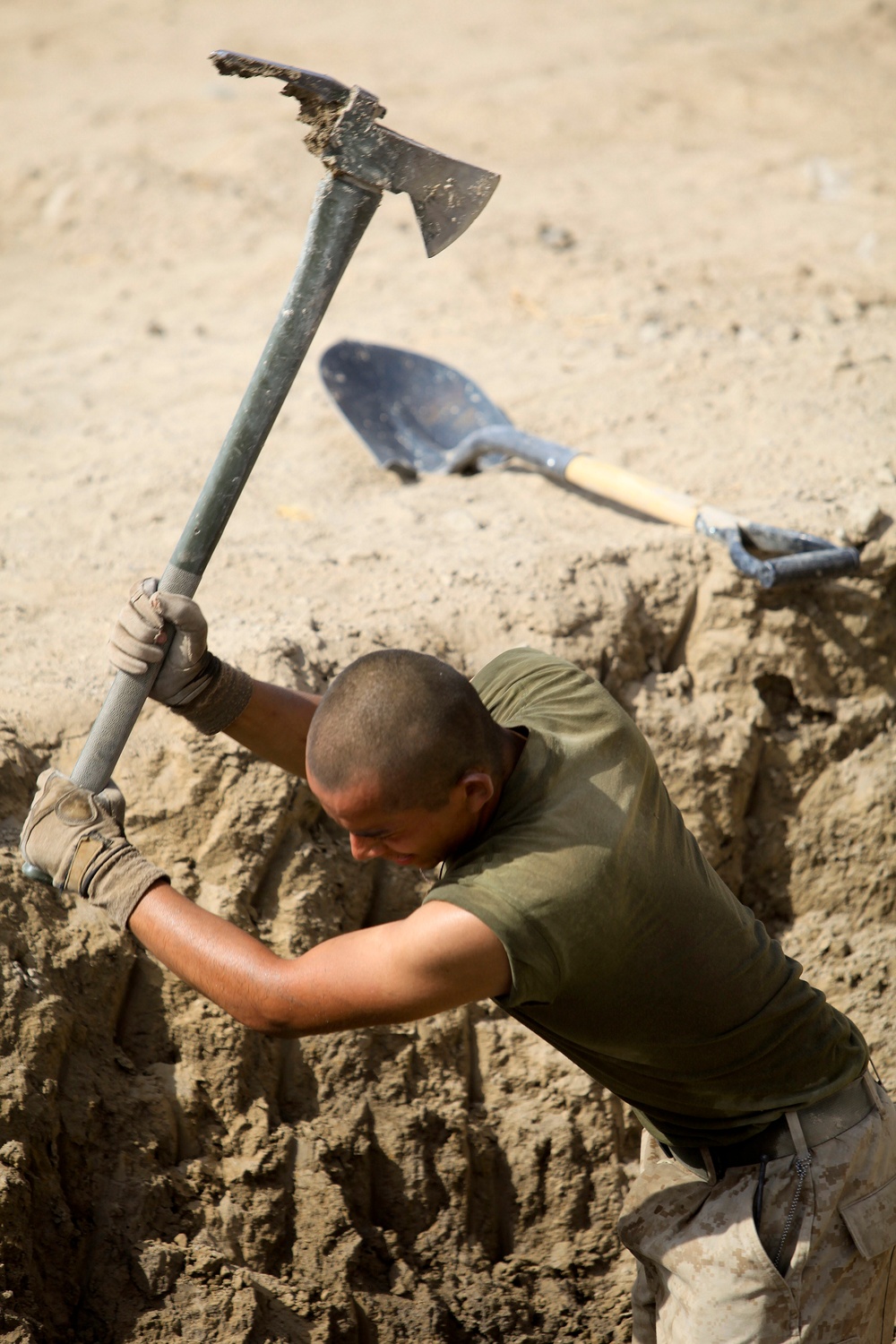 A U.S. Marine digs a fighting position at Patrol Base Jaker.