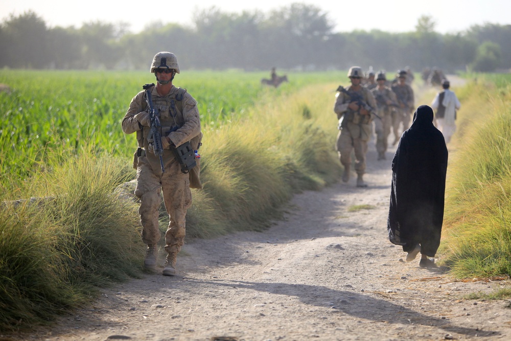 Afghan National Army soldiers and U.S. Marines conduct a road reconnaissance patrol.