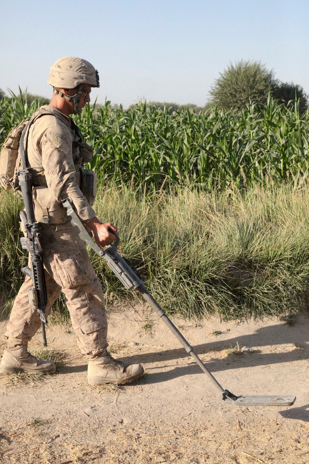 Lance Cpl. Daniel Bemenderfer uses a mine sweeper to search for improvised explosive devices.