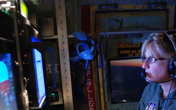 Capt. Tina Smith monitors data obtained during a mission through tropical storm Felicia.