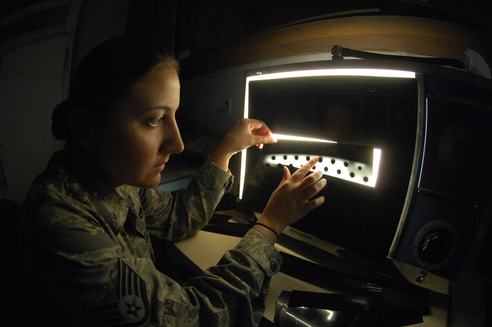 Staff Sgt. Nadine Muro examines an X-ray film strip of B-52 Stratofortress aircraft parts. Staff Sgt. Nadine Muro examines an X-ray film strip of B-52 Stratofortress aircraft parts.