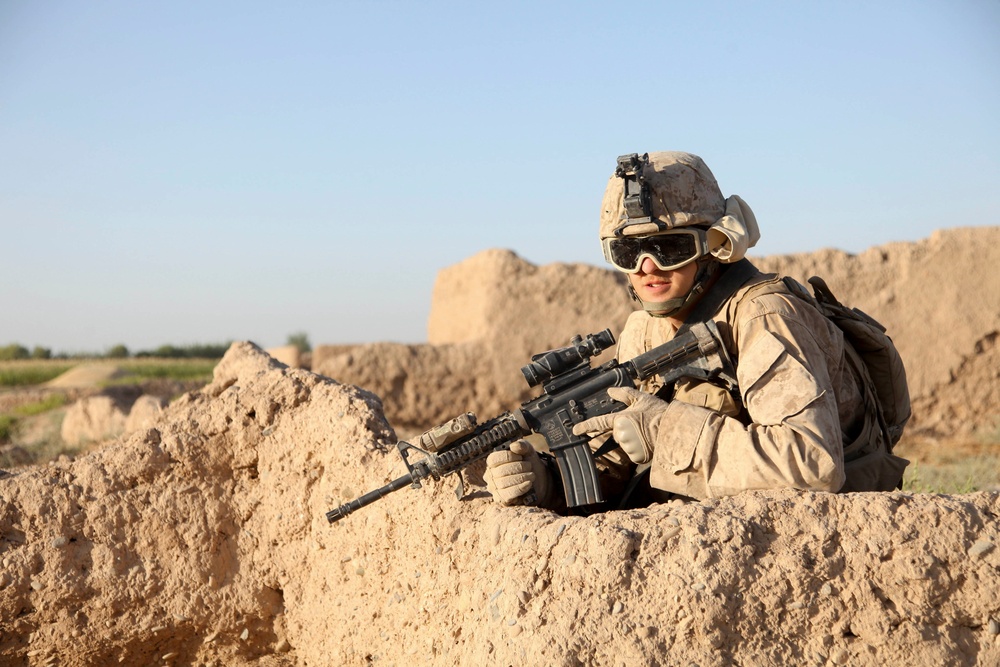 A U.S. Marine provides security during a road reconnaissance patrol.