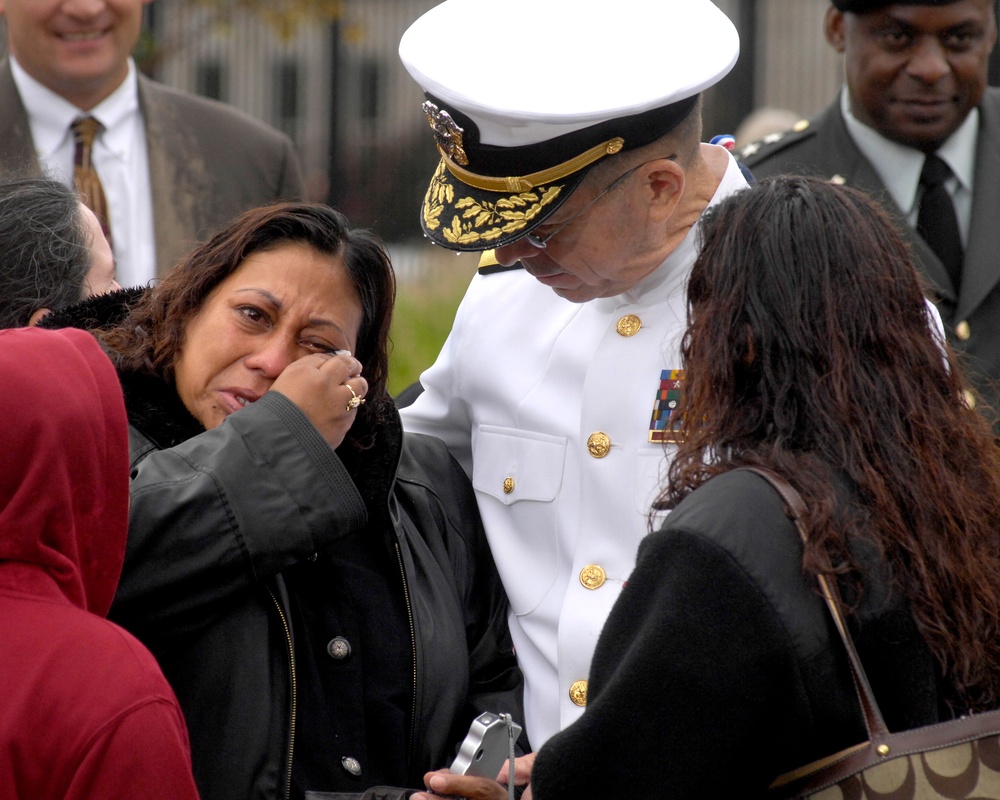 Adm. Mike Mullen comforts a family member at the Pentagon Memorial.