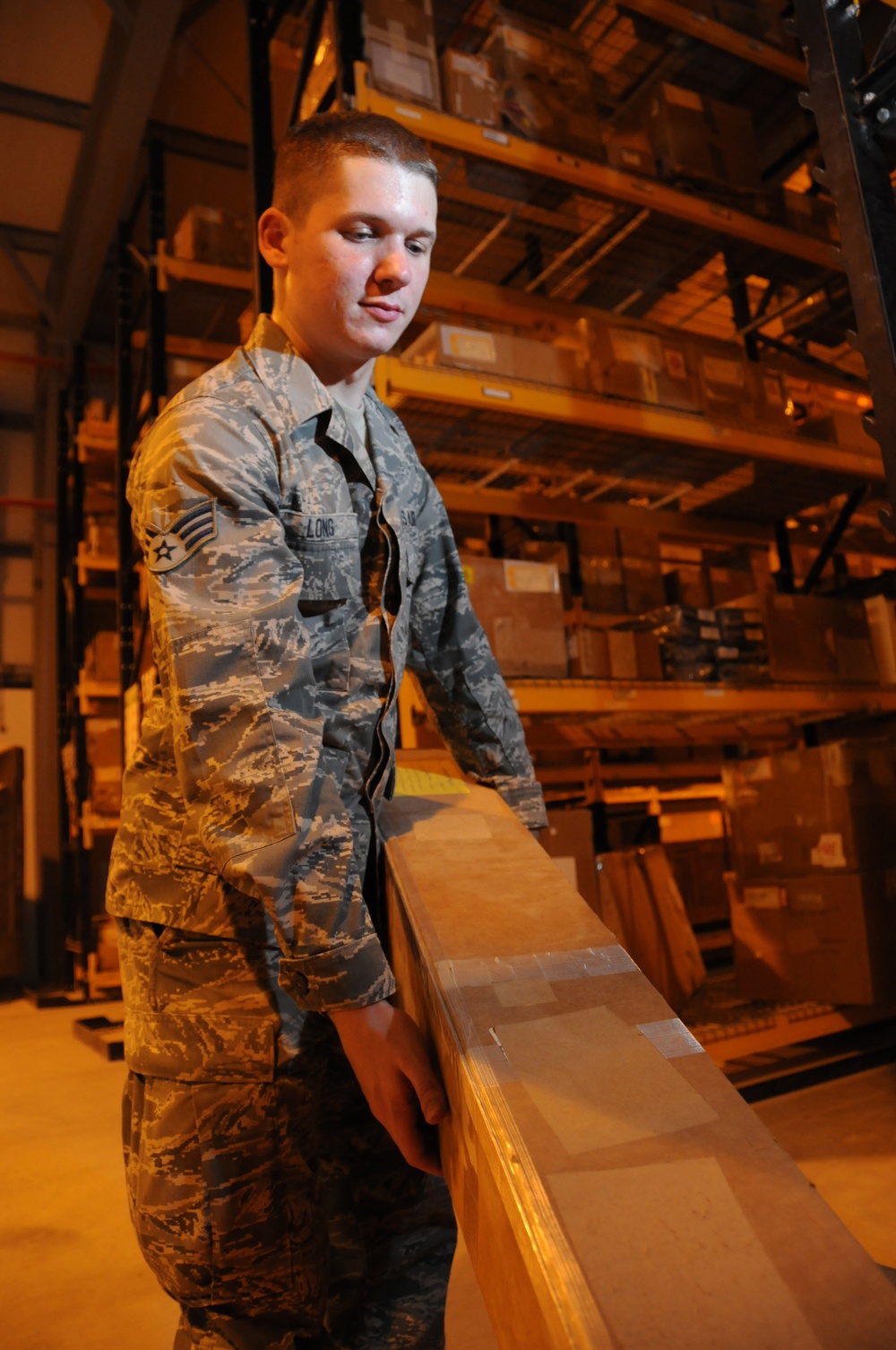 Senior Airman Dustin Long prepares a supply order.