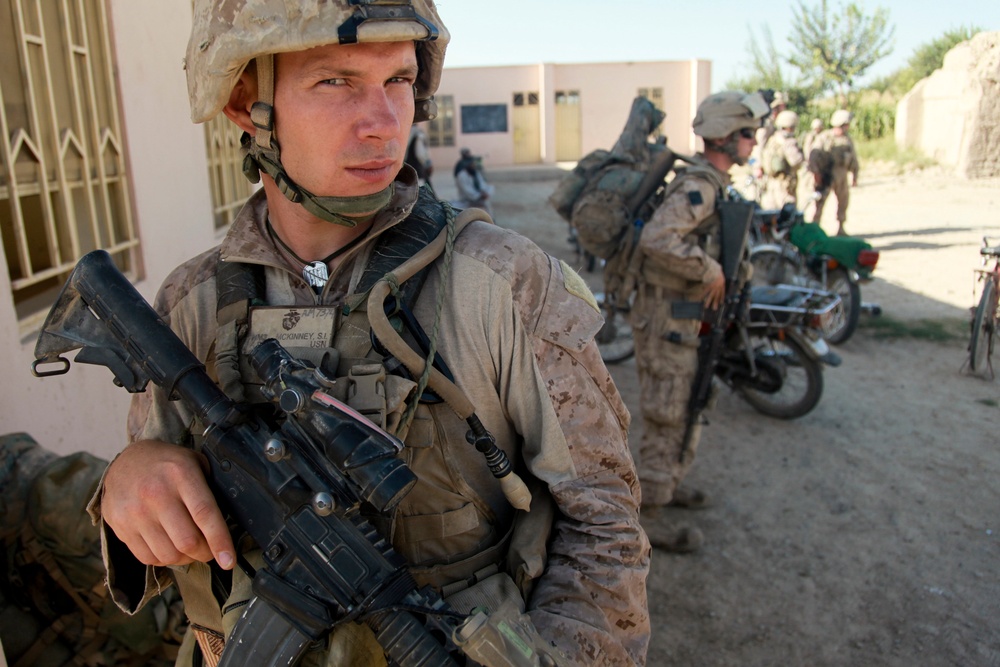 Petty Officer 2nd Class Shawn McKinney provides security during a shura, or consultation.