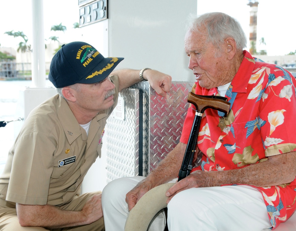 Retired U.S. Navy Lt. John W. Finn speaks with Capt. Richard Kitchens.