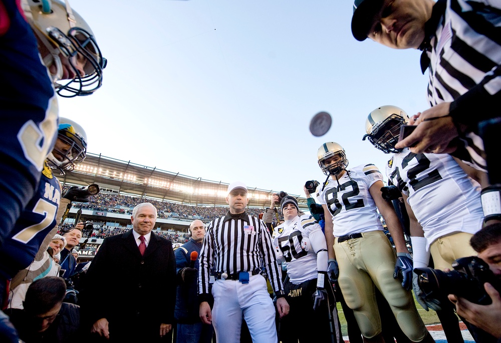 Secretary Gates tosses the coin to kick off the 110th Army vs. Navy football game.