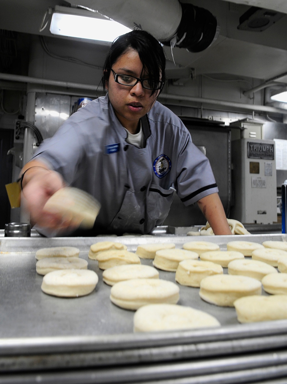 Seaman Lindsey Ocampo prepares breakfast pastries.