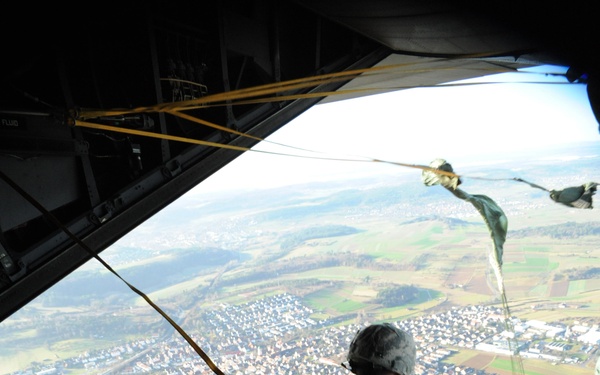 Members of Special Operations Command Europe jump from the ramp of an MC-130 Combat Talon aircraft.