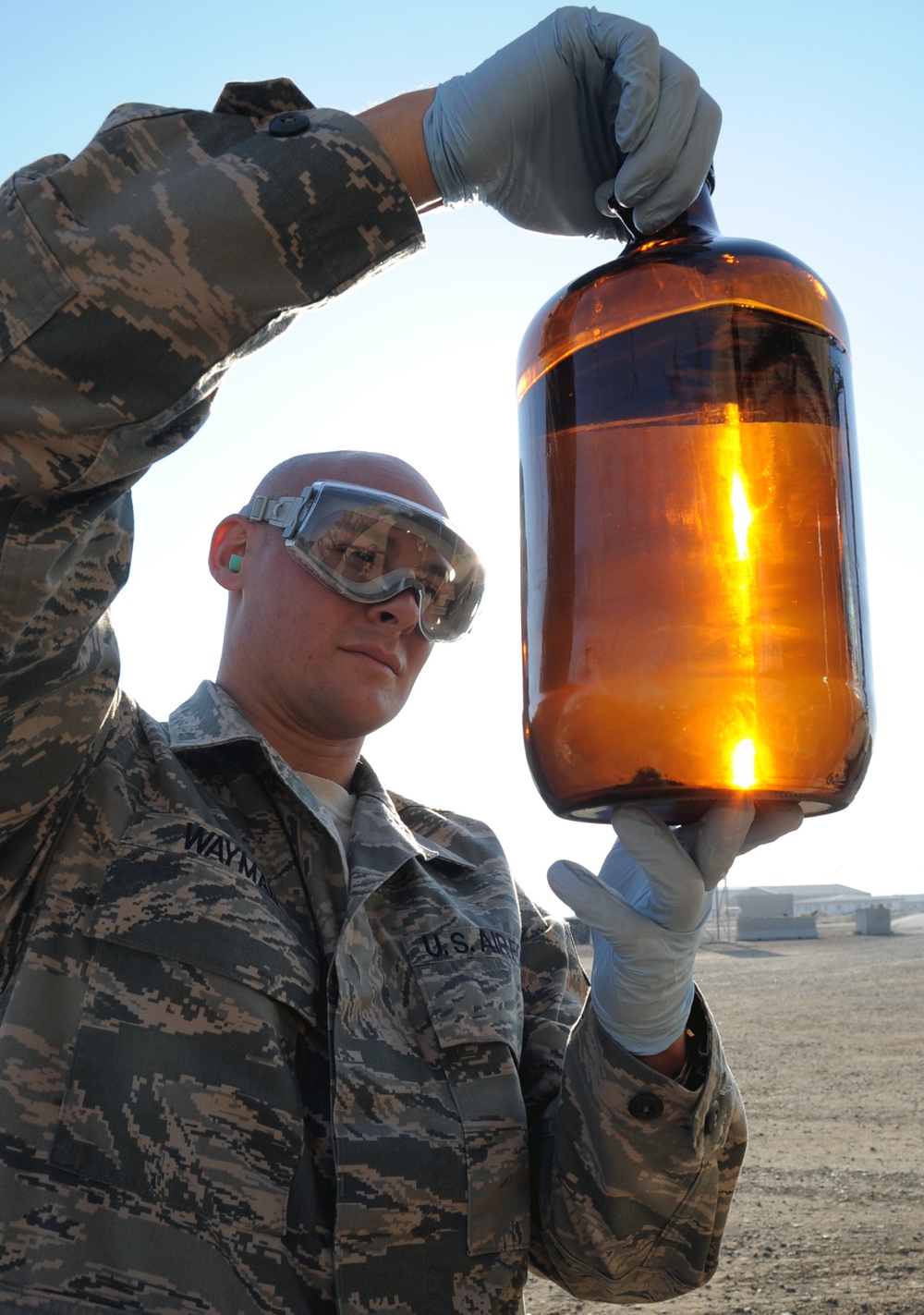 Staff Sgt. Craig Wayman checks a sample of fuel from a fuels truck.