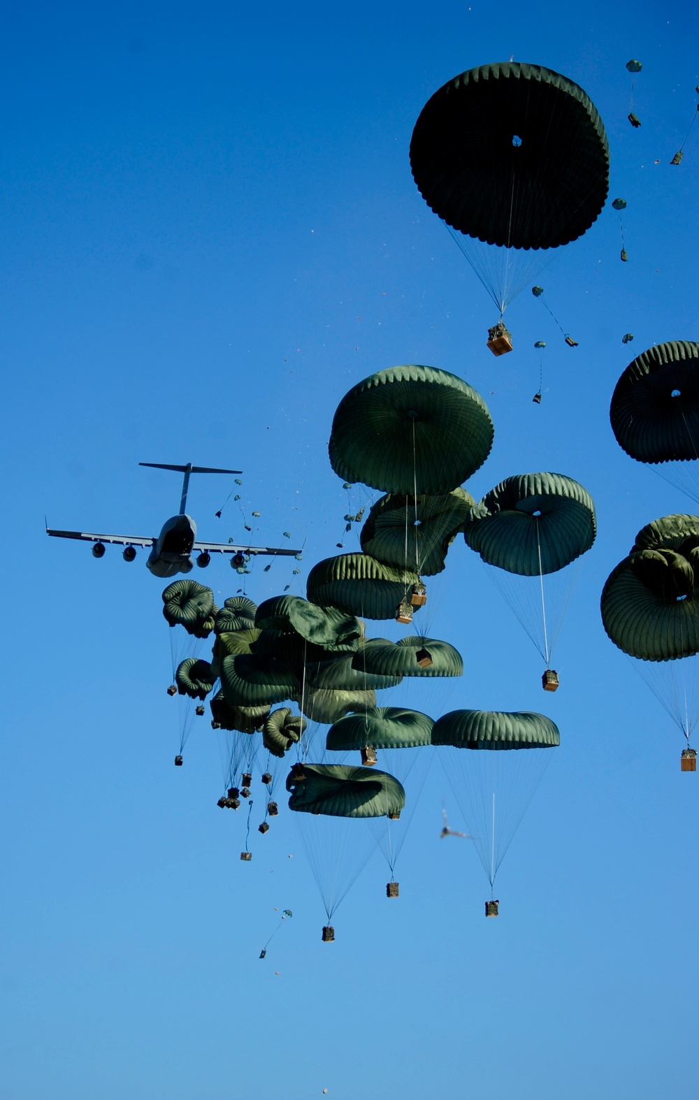 A U.S. Air Force C-17 Globemaster III aircraft airdrops humanitarian aid into Port-au-Prince.