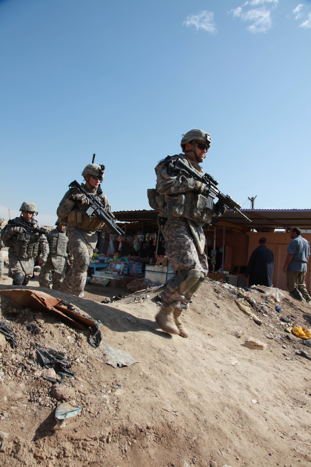 U.S. Army soldiers walk through a market.