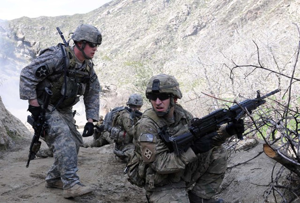 U.S. Army soldiers prepare to move from cover during an attack.
