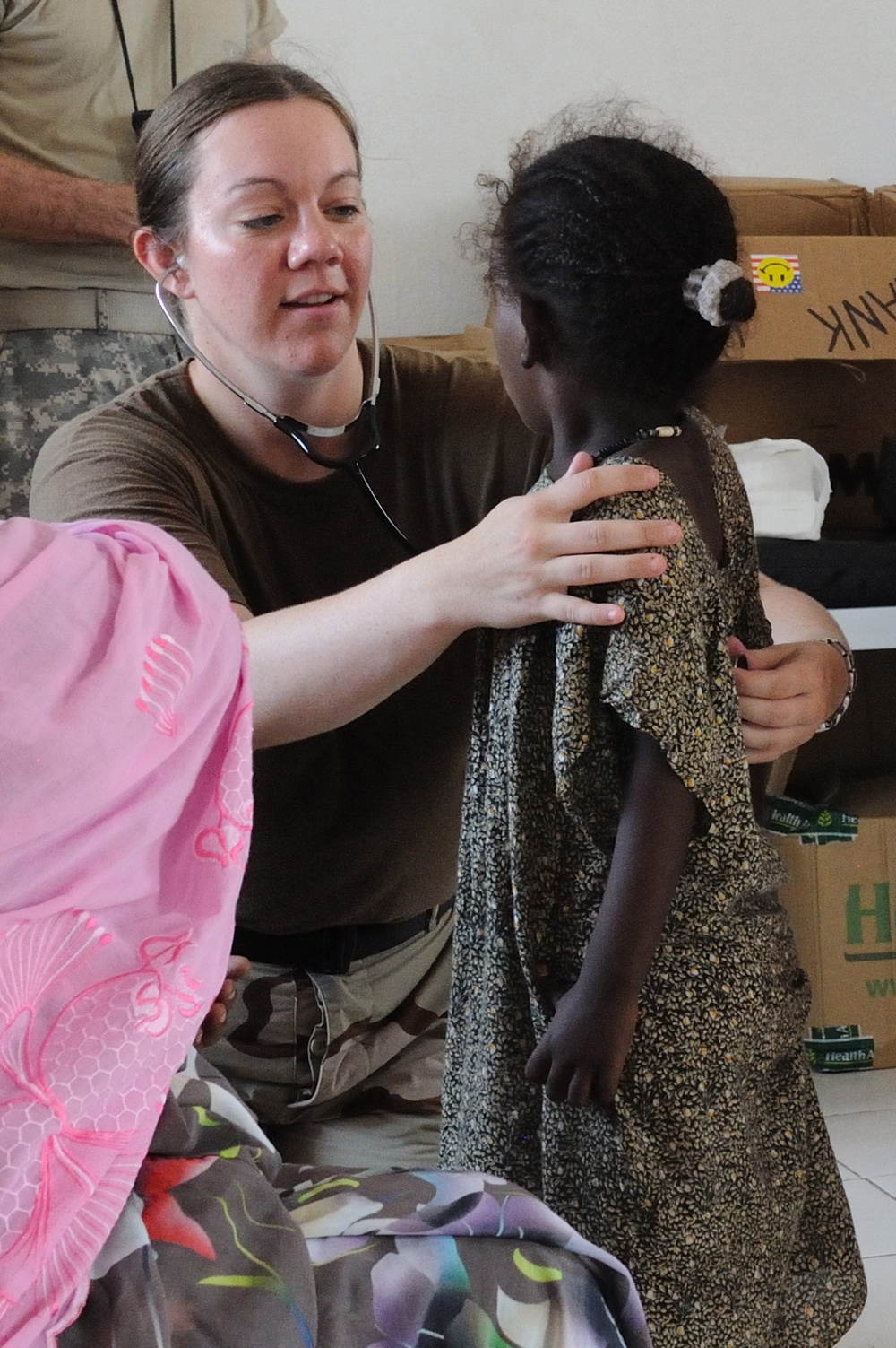 Lt. j.g. Julie Cole examines a child during a medical civic action program.