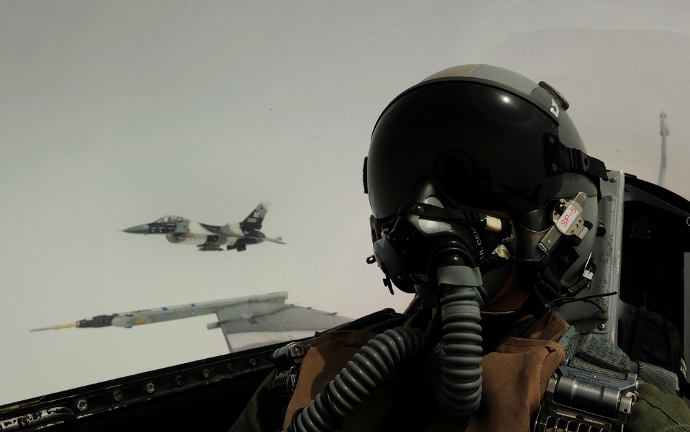 Tech. Sgt. James L. Harper Jr. takes a self-portrait with an F-16 Aggressor aircraft.