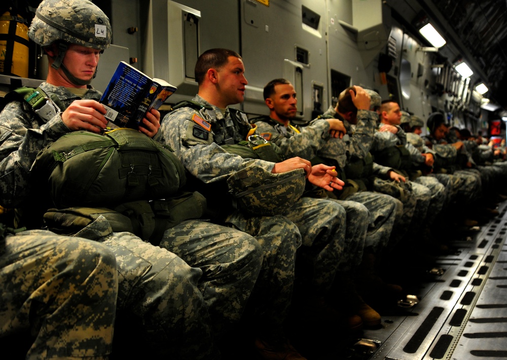 Pfc. Kyle Somerlot reads a book aboard a C-17 Globemaster III cargo aircraft.