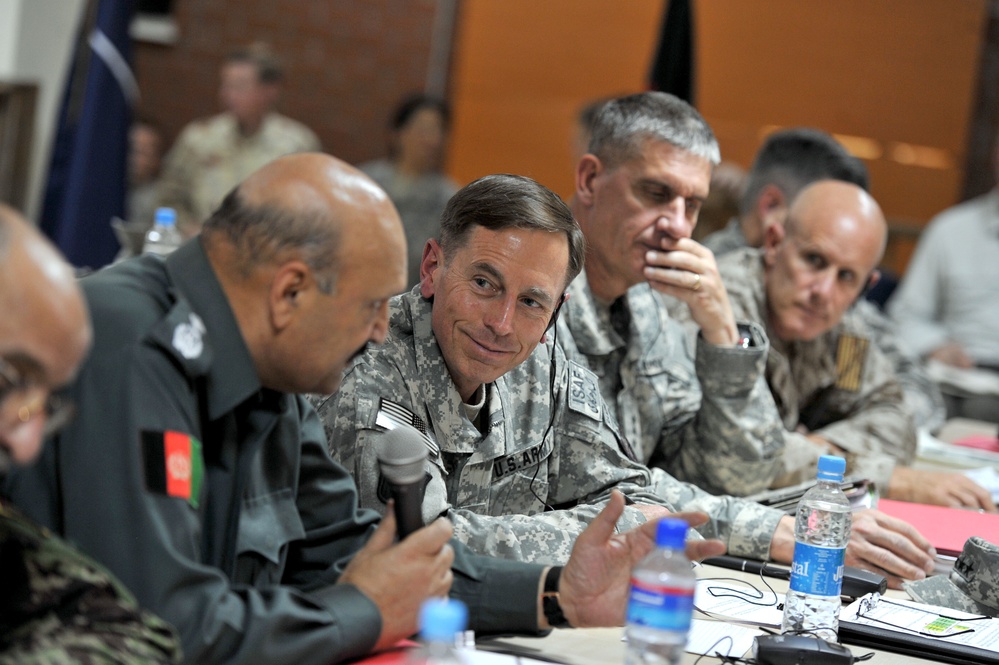 Gen. David H. Petraeus speaks with Afghan Minister of Security Gen. Munir Mangal.
