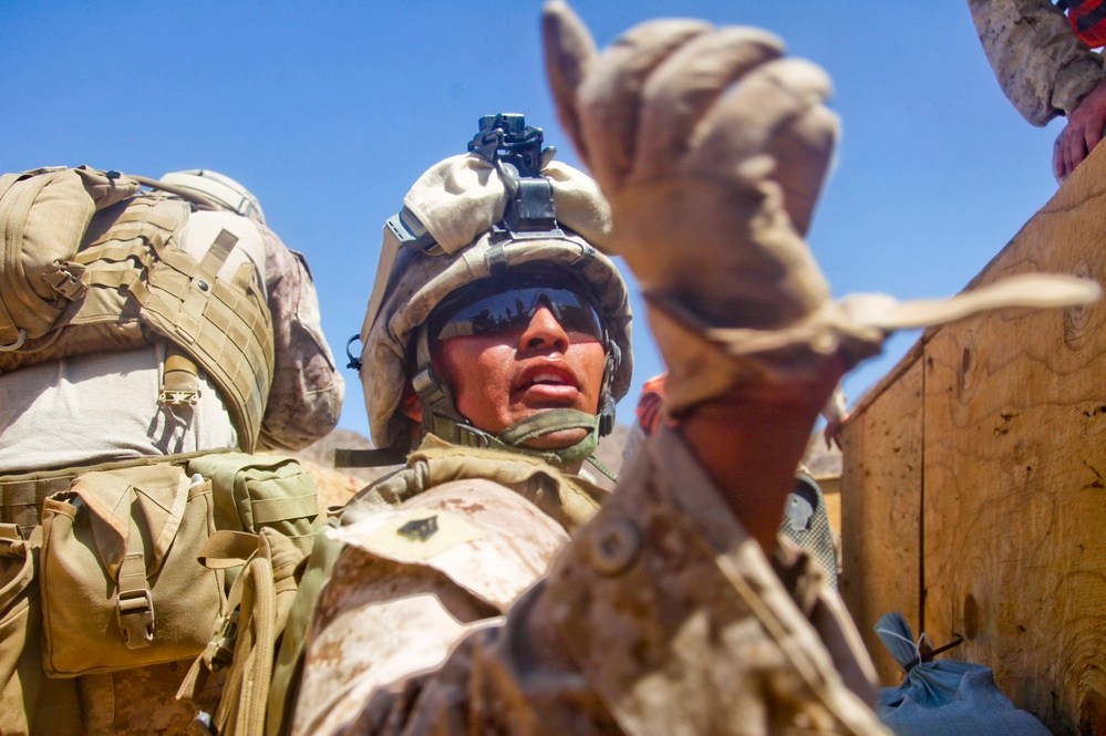 Sgt. D.B. Castillo instructs his Marines to continue fire suppression fire.