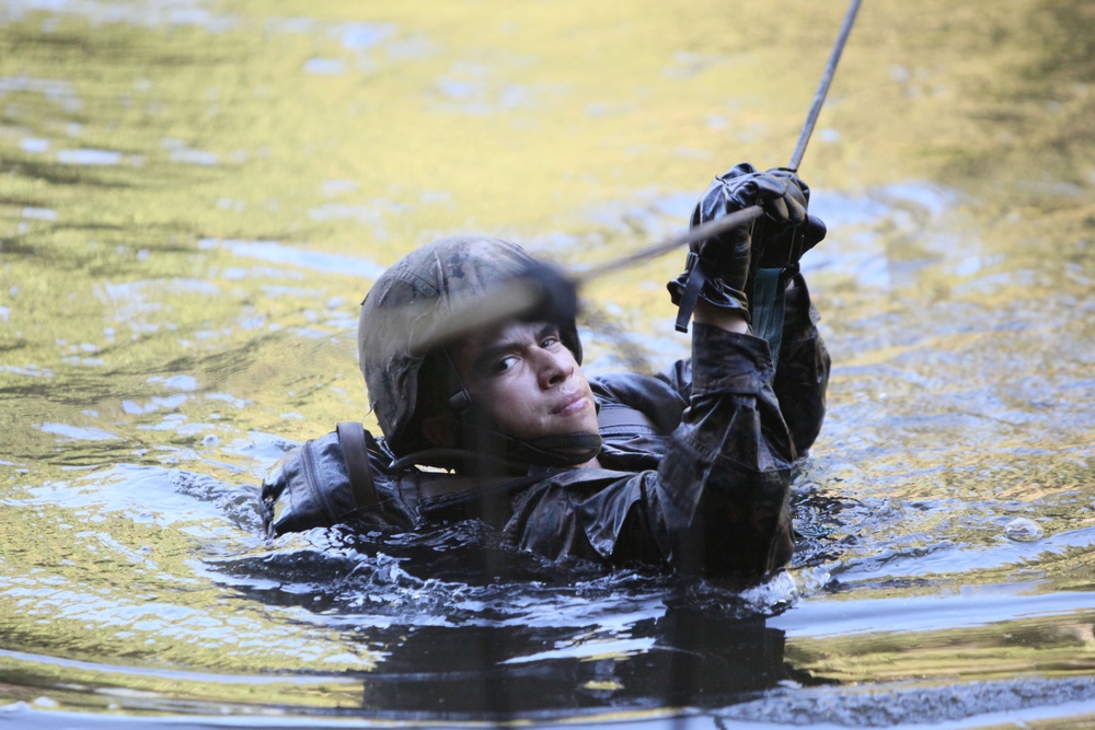 A U.S. Marine crosses a river during jungle warfare training.