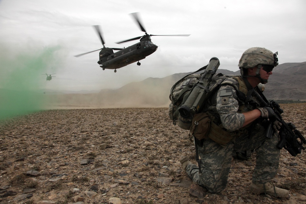 Spc. Kevin Welsh provides security before boarding a CH-47 Chinook helicopter.