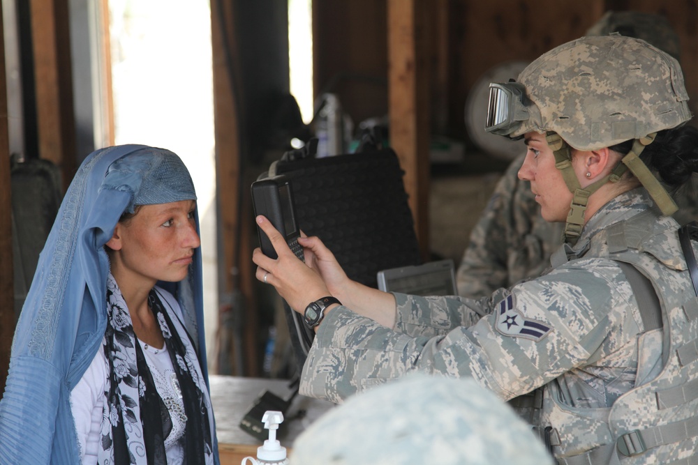 Airman 1st Class Jennifer Marchese scans an Afghan woman's iris.